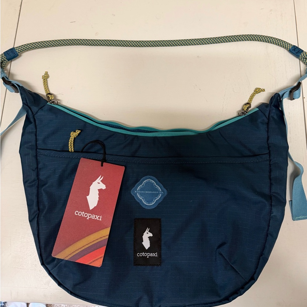 Cotopaxi Navy Crossbody Bag with Teal Accents